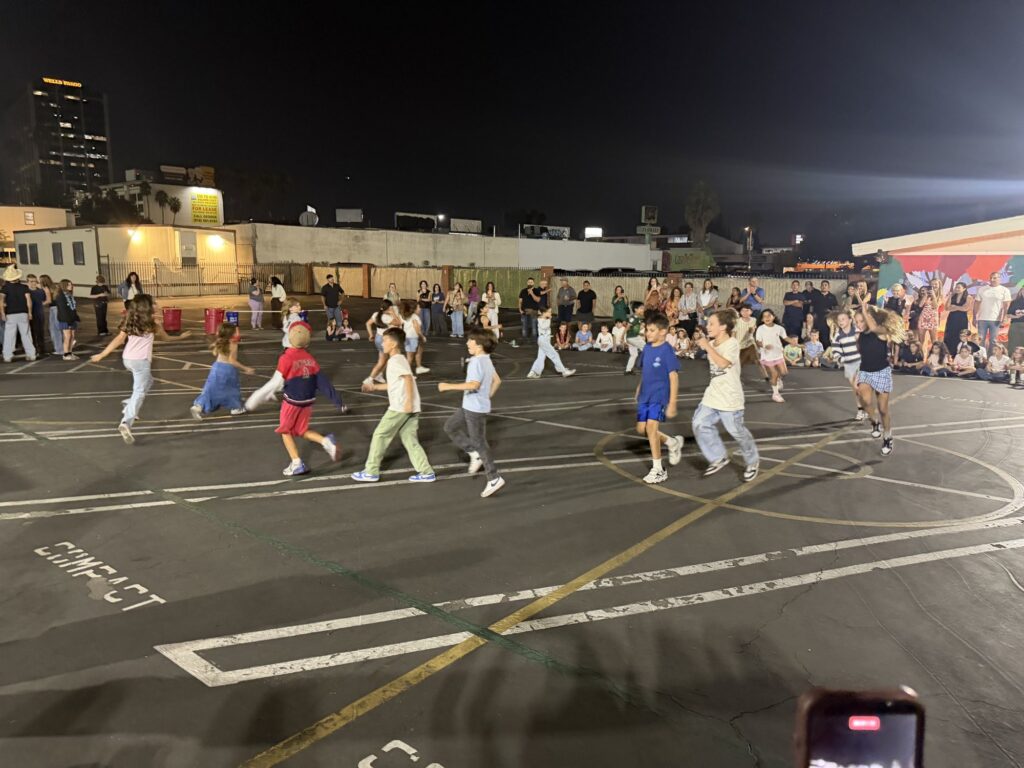 Kids running and dancing across the blacktop