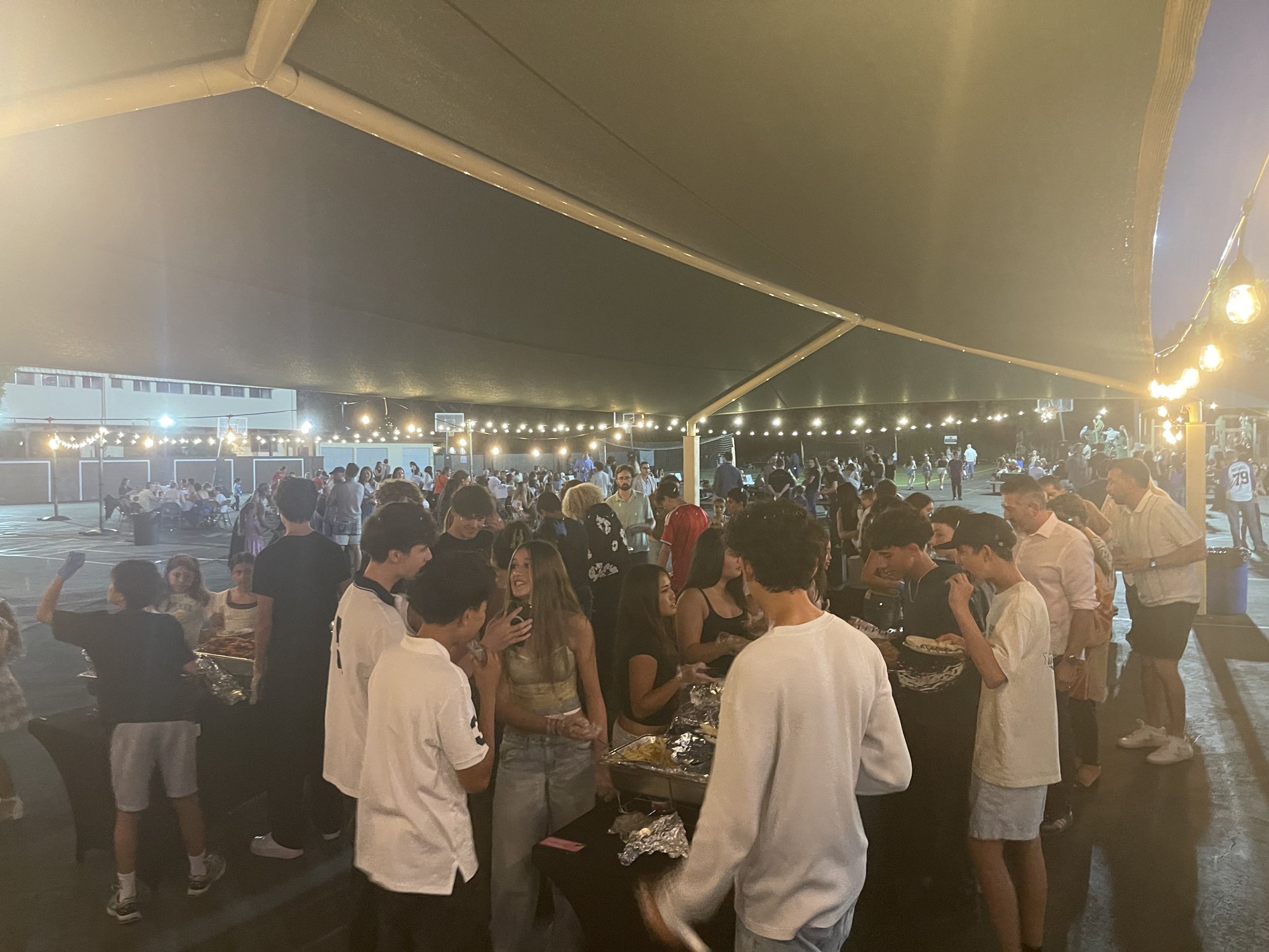 Guests mingling under the string lights at the 2026 Family Dinner Dance